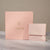 Close-up of a blush pink Chupi luxury packaging sleeve with gold logo.