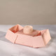 Luxury box exposing a blush jewelery pouch to hold jewellery.