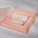 Luxury box exposing a blush jewelery pouch to hold jewellery.