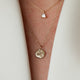 Close-up of two layered necklaces, featuring the North Star Diamond Engraved Initial Necklace.