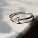 Close-up of a hand wearing the Sterling Silver Moon Ring, highlighting the polished band and moon detail.