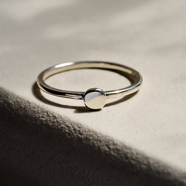 Alternative view of Close-up of a hand wearing the Sterling Silver Sun Ring, highlighting the polished band and sun detail.