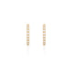 Close-up of a model's ear wearing the Today Diamond Eternity Huggies in 14k gold.
