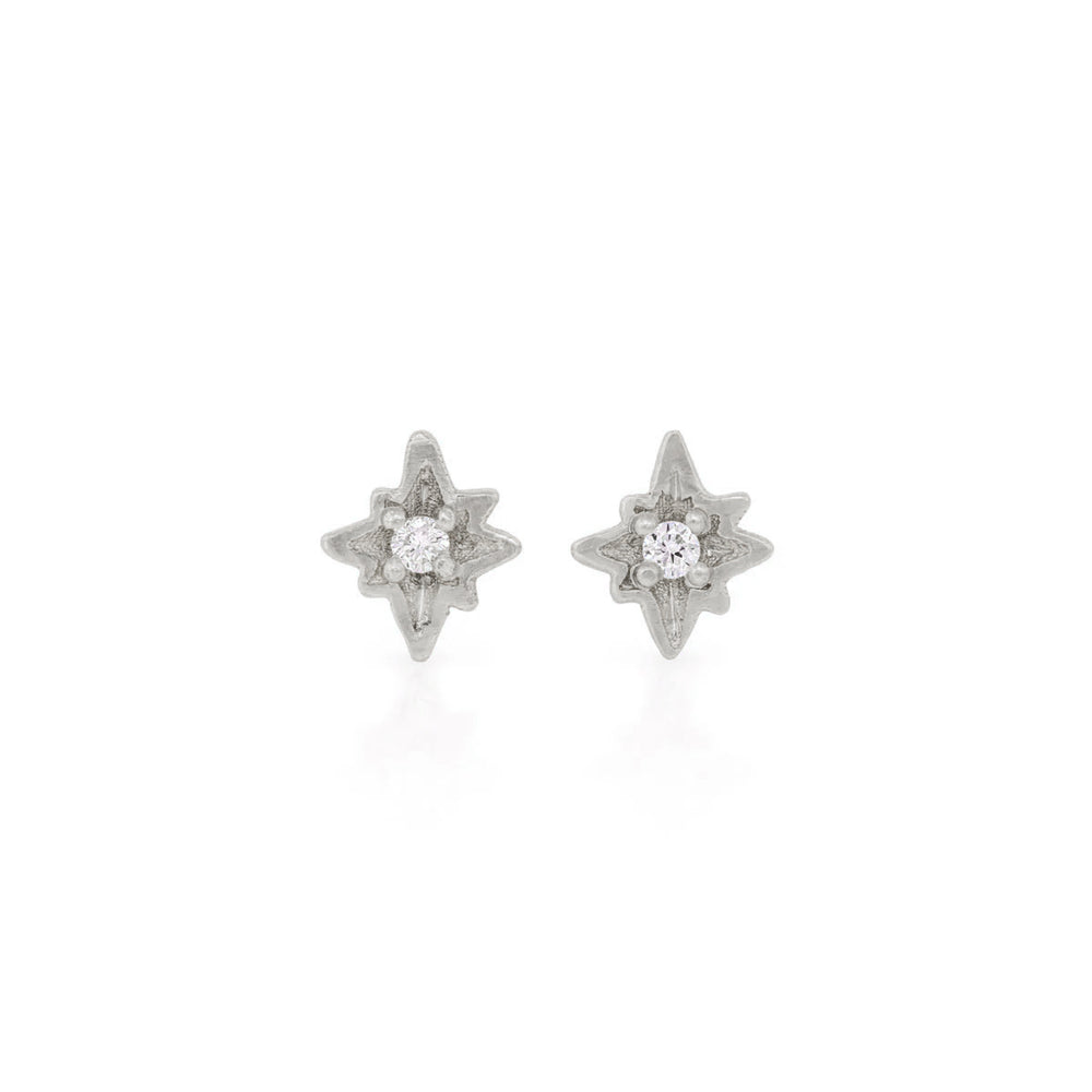 Front view of the North Star Diamond Stud Earrings in 14k white gold, featuring a bezel-set diamond in a starburst setting.
