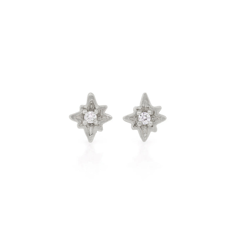 Front view of the North Star Diamond Stud Earrings in 14k white gold, featuring a bezel-set diamond in a starburst setting.