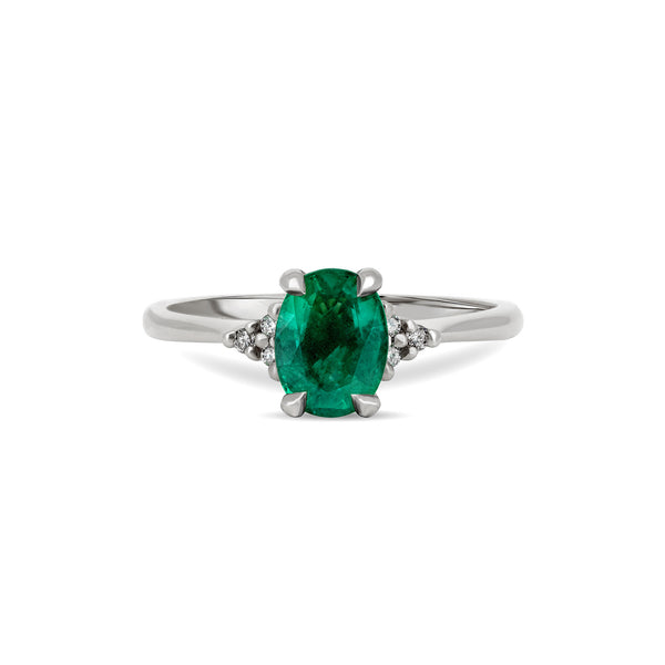 Front view of the Dewlight Emerald Engagement Ring in 14k white gold, featuring a large oval stone on a polished band.