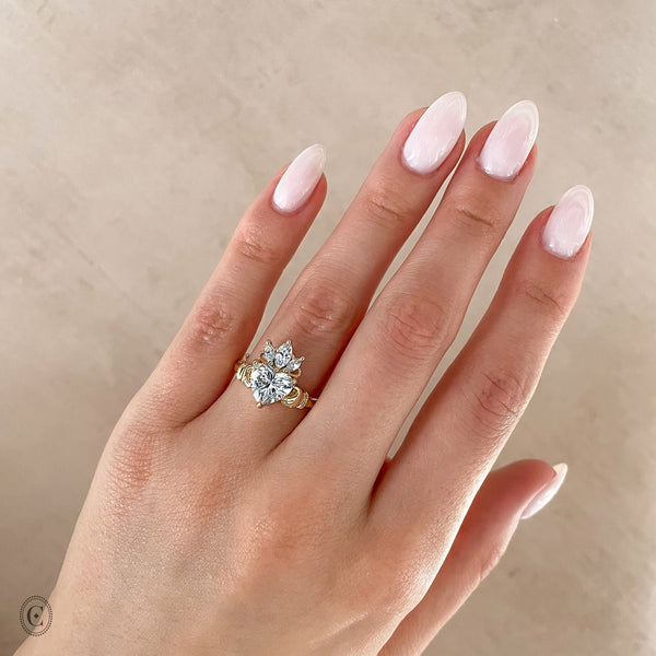 Alternative view of Close-up of a hand wearing the Claddagh Heart Cut Diamond Ring showcasing the heart diamond and crown motif.