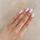 Close-up of a hand wearing the Driftwood 14k White Gold Slim Wedding Band.