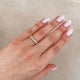Close-up of a hand wearing the Follow Your Path Diamond Eternity Ring in 14k solid gold.