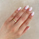 Close-up of a hand wearing the Hawthorn Bark 4mm Men's Wedding Band in 14k polished gold.