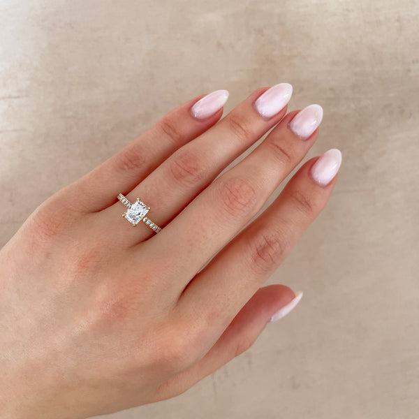 Alternative view of Close-up of a hand wearing the Heritage Eternity Radiant Cut Diamond Engagement Ring in 14k solid gold.