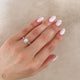 Close-up of a hand wearing the Heritage Eternity Radiant Cut Diamond Engagement Ring in 14k solid gold.
