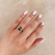 Close-up of a hand wearing the Hero 1.8ct Green Tourmaline & Diamond Ring in 14k polished gold.