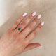Close-up of a hand wearing the Hero 1ct Green Tourmaline Ring in 14k solid gold.