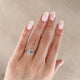 Close-up of a hand wearing the Hero Emerald Cut Three Stone Diamond Engagement Ring in 14k white gold.