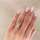 Close-up of a hand wearing the Moonlight Oval Diamond Engagement Ring in 14k solid gold, on a twig band.