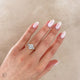 Close-up of a hand wearing the One in a Trillion 2.4ct Lab-Grown Oval Diamond Engagement Ring in 14k gold with a twig band.