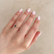 Close-up of a hand wearing the Promise me Tomorrow Blue Sapphire Ring in 14k white gold.