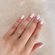 Close-up of a hand wearing the Promise Me Diamond Ring in 14k white gold.