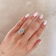 Close-up of a hand wearing the Queen of Hope 2.7ct Lab-Diamond Engagement Ring in 14k white gold.