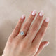Close-up of a hand wearing the Starlight Oval Diamond Engagement Ring in 14k solid gold.