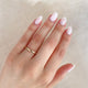 Close-up of a hand wearing the Timeless Love 2mm Wedding Band in 14k white gold.
