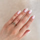 Close-up of a hand wearing the Whispered Dreams Lab-Grown Diamond Double Cluster Ring in 14k solid gold.