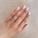 Close-up of a hand wearing the Whispered Dreams Lab-Grown Diamond Cluster Ring in 14k white gold.