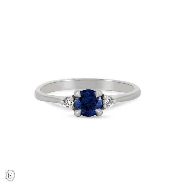 Front view of the Love is All Blue Sapphire Engagement Ring in 14k white gold, featuring a blue sapphire on a polished band.