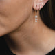 Raindrop Diamond Earrings in 14k white gold on a model's ear, highlighting the clustered diamond arrangement.