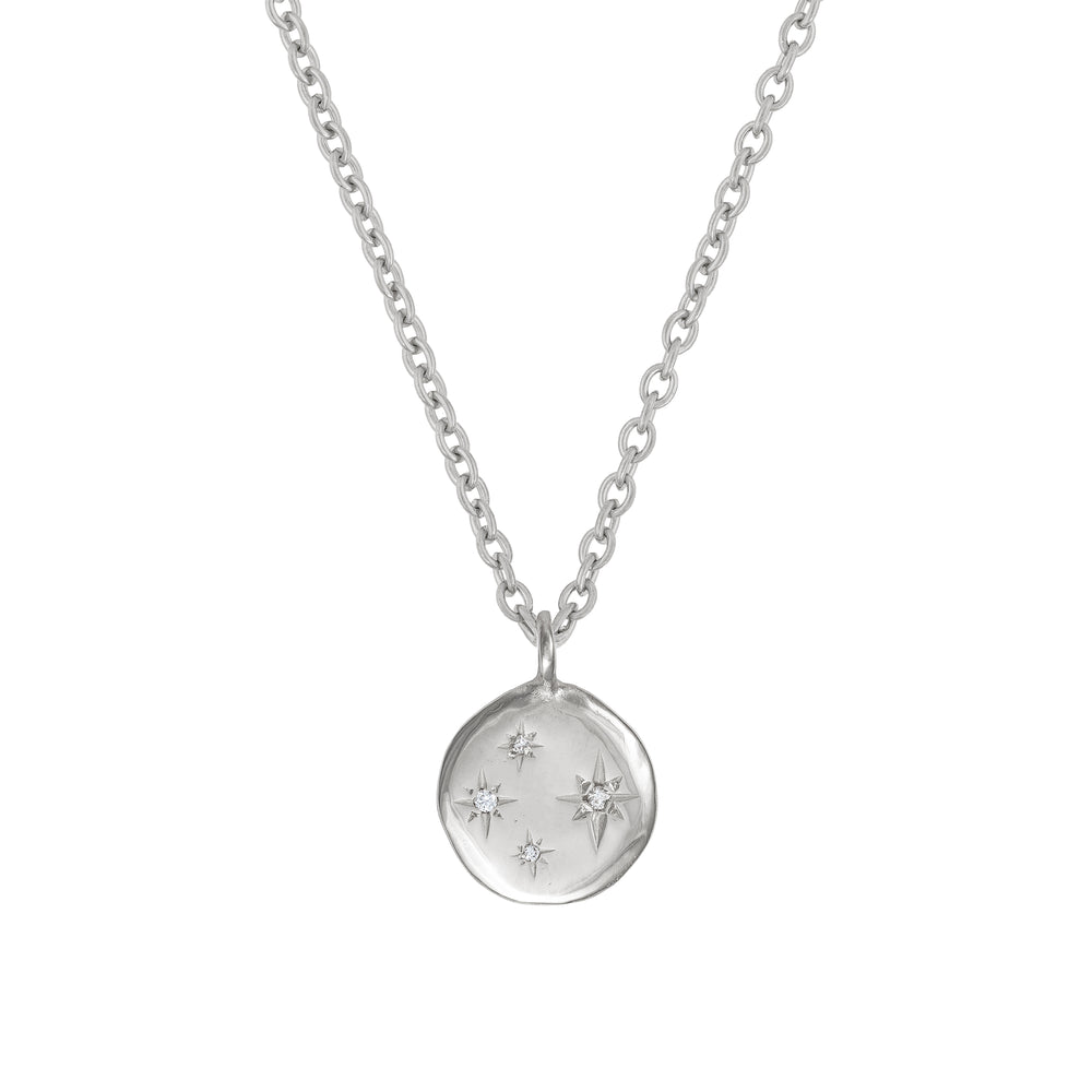 Front view of the Stars in the Sky Four Diamond Necklace in 14k white gold, featuring four scattered diamonds on a round pendant.