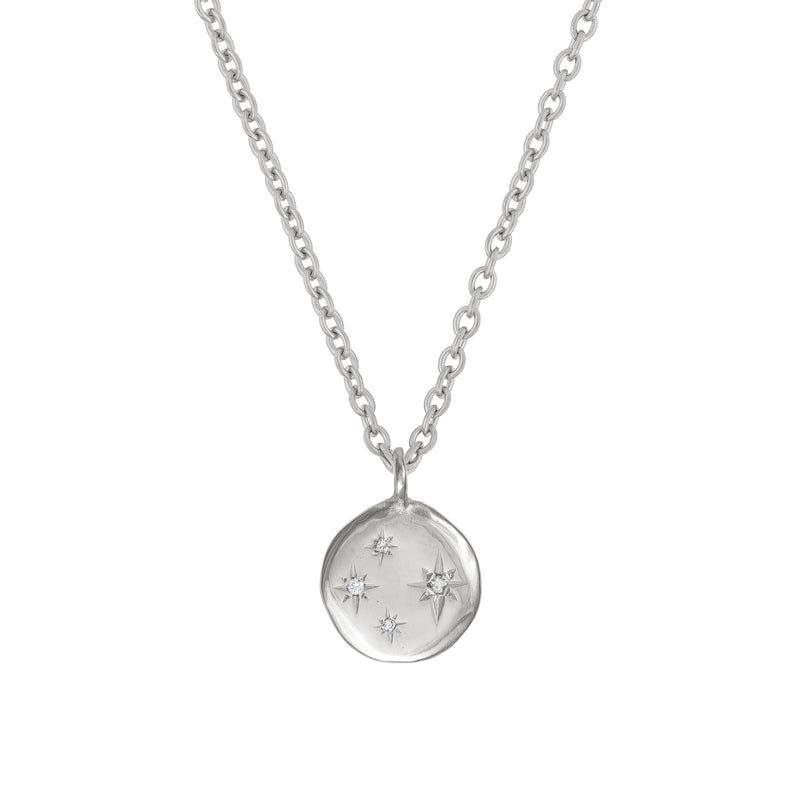 Front view of the Stars in the Sky Four Diamond Necklace in 14k white gold, featuring four scattered diamonds on a round pendant.