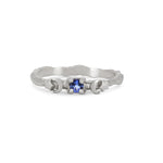Thumbnail of Front view of the Sun, Moon & Stars Tanzanite Ring in 14k white gold, featuring a round tanzanite stone flanked by sun, moon, and star motifs on a twig band.