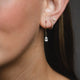 Teardrop Diamond Earrings in 14k gold on a model's ear, highlighting the clustered diamond arrangement.