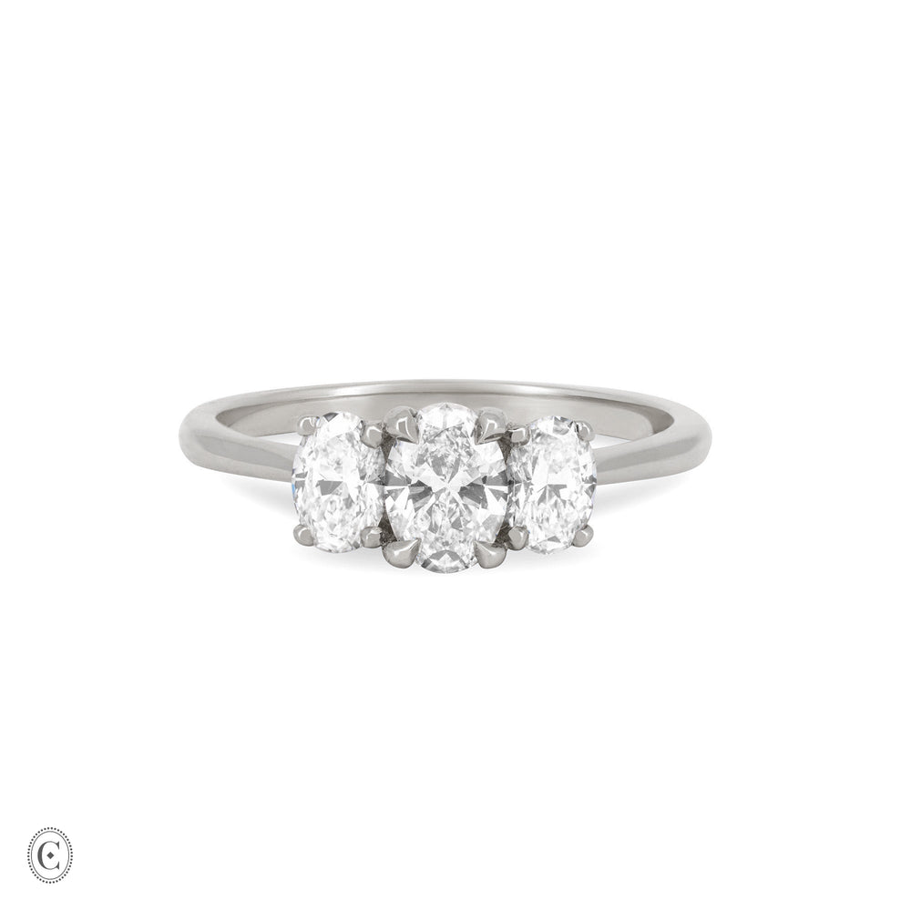 Front view of the Guiding Light Trilogy Oval Diamond Engagement Ring in 14k white gold, featuring a central oval diamond flanked by two smaller diamonds on a polished band.