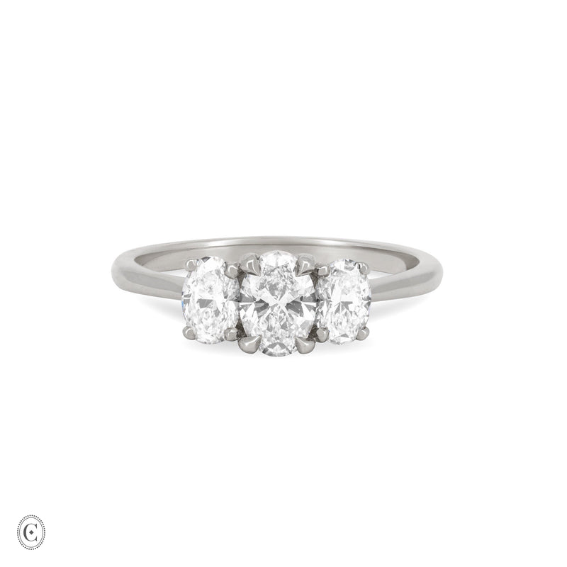 Front view of the Guiding Light Trilogy Oval Diamond Engagement Ring in 14k white gold, featuring a central oval diamond flanked by two smaller diamonds on a polished band.