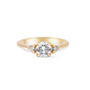 Thumbnail of Front view of the You, Me & Magic Round Cut Three Stone Engagement Ring in 14k solid gold, featuring a 0.7ct central round cut diamond flanked by two smaller stones on a polished band.