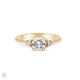 Front view of the You, Me & Magic Round Cut Three Stone Engagement Ring in 14k solid gold, featuring a 0.7ct central round cut diamond flanked by two smaller stones on a polished band.