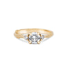 Thumbnail of Front view of the You, Me & Magic Round Cut Three Stone Engagement Ring in 14k solid gold, featuring a 0.7ct central round cut diamond flanked by two smaller stones on a twig band.