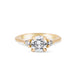 Front view of the You, Me & Magic Round Cut Three Stone Engagement Ring in 14k solid gold, featuring a 1ct central round cut diamond flanked by two smaller stones on a polished band.