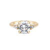 Thumbnail of Front view of the You, Me & Magic Round Cut Three Stone Engagement Ring in 14k solid gold, featuring a 2ct central round cut diamond flanked by two smaller stones on a polished band.