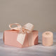 Close-up of a blush pink Chupi luxury packaging box.