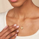 Model wearing the Stars in the Sky Four Diamond Necklace in 14k gold.